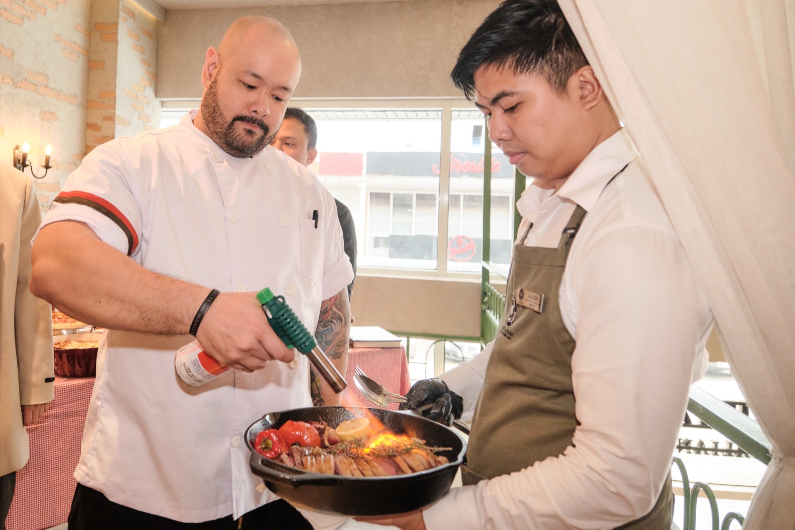 Chef Matt Navarro torching a signature steak at the Sicilian Roast Molito media preview